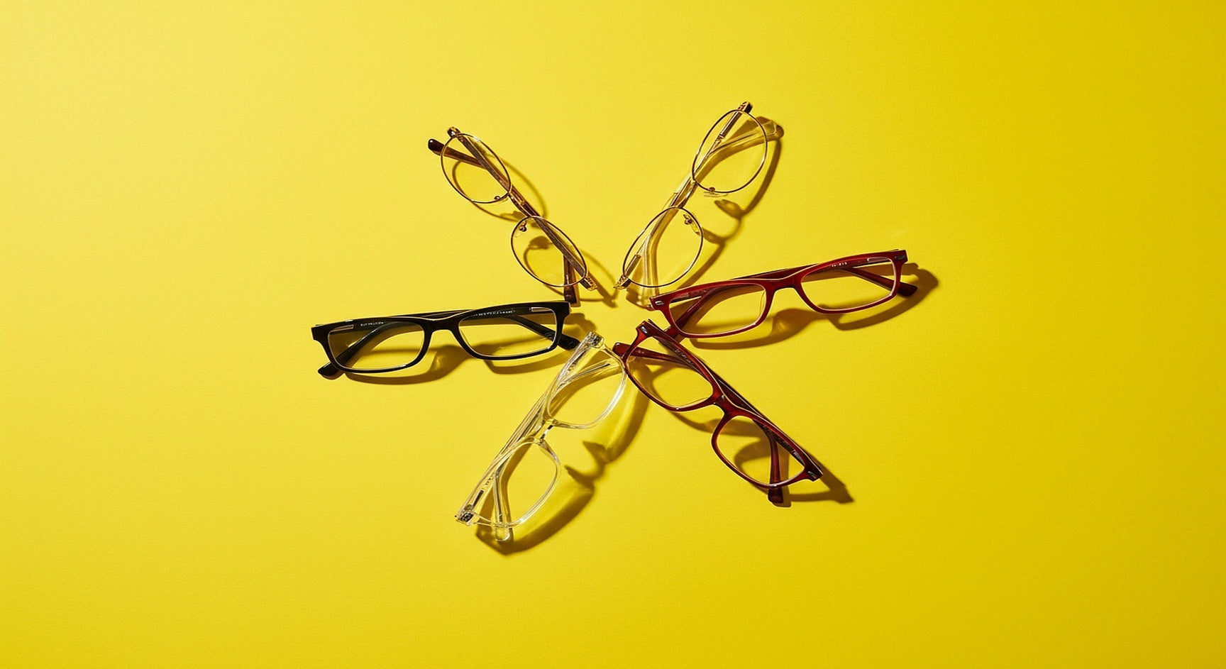 Single vision lenses guide showing five prescription eyeglass frames in starburst on vivid yellow surface