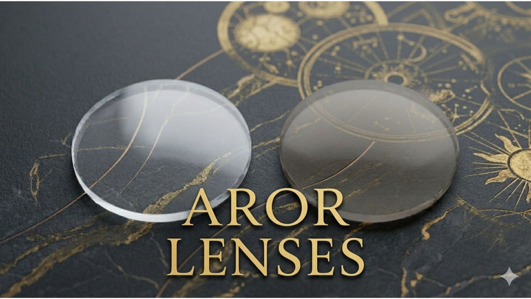 Two uncut round Aror CR-39 optical lens blanks — one clear and one subtly tinted photochromic — resting on a marble surface, representing the Aror single vision and progressive lens collection available 