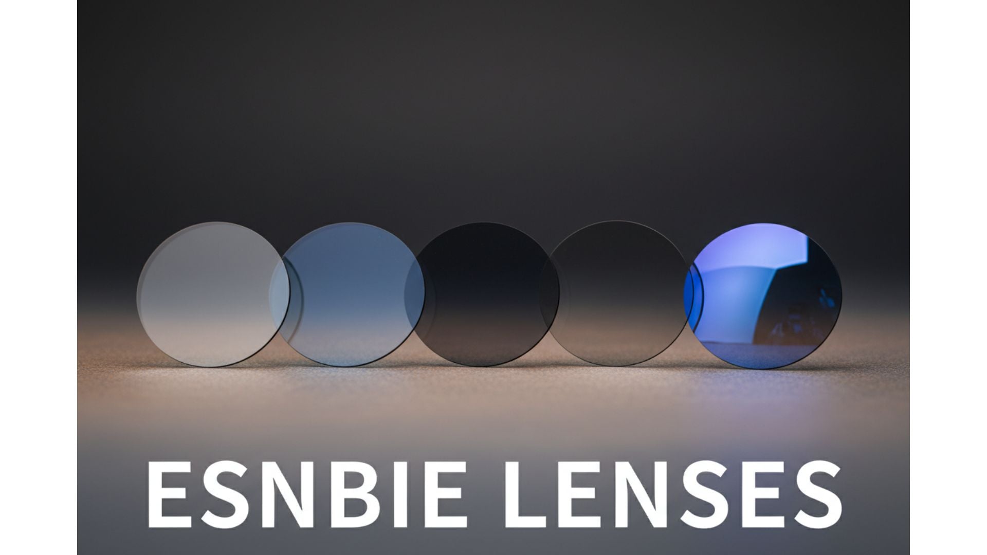 Five uncut round Esnbie optical lens blanks arranged in an arc — clear, anti-blue, tinted, photochromic gray, and polarized — representing the full Esnbie single vision and progressive lens range available