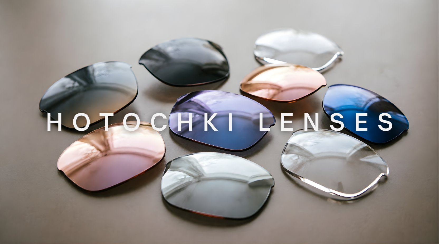 FuzWeb Hotochki lenses collection featuring polarized progressive photochromic and anti-blue light lenses in CR-39 resin on soft warm taupe studio background with natural lighting