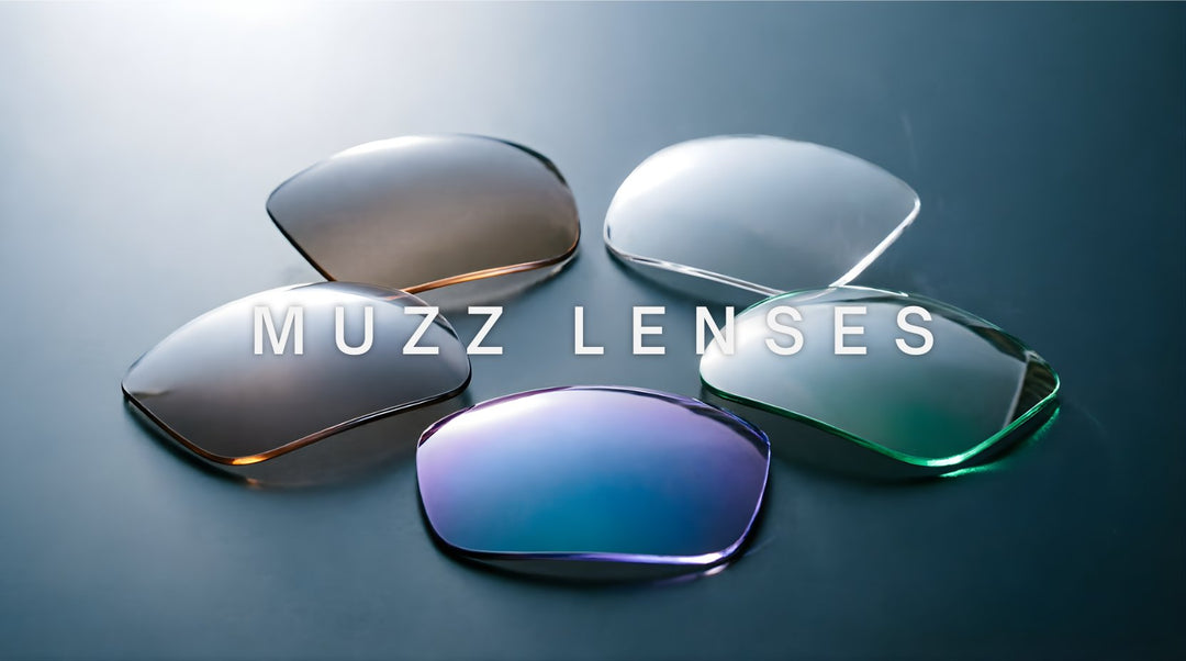 FuzWeb Muzz lenses collection featuring aspheric progressive photochromic polarized and anti-blue light lenses on deep teal-gray studio background with dramatic back-left lighting