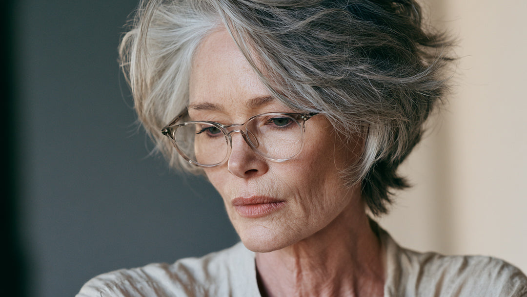 Woman reading through clear-framed prescription reading glasses